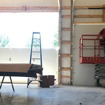 Royal Door - Royal Door Worker on Aerial Platform in Commercial Building - Garage Door Services Near Me - Lee's Summit, Missouri Royal Door - Royal Door Worker on Aerial Platform in Commercial Building - Garage Door Services Near Me - Lee's Summit, Missouri