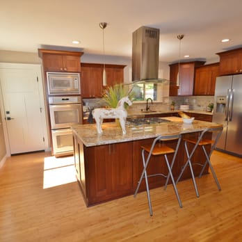 Total Property Solutions - a kitchen with hardwood floors and stainless steel appliances - Property Management Near Me - Concord, California Total Property Solutions - a kitchen with hardwood floors and stainless steel appliances - Property Management Near Me - Concord, California