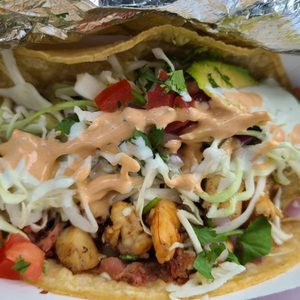 Photo of Oscars Mexican Seafood - San Diego, CA, United States. Taco Especial with smoked fish, shrimp, and scallops.
