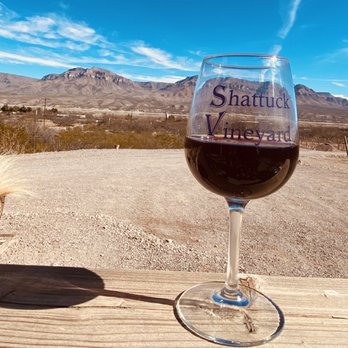 Shattuck Vineyard - a glass of wine on a wooden table - Wineries Near Me - Caballo, New Mexico