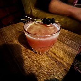 a drink in a glass on a wooden table a drink in a glass on a wooden table