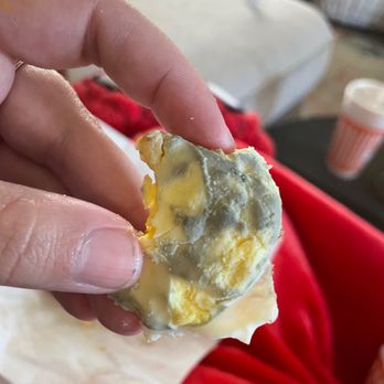 Whataburger - a hand holding a piece of food - Burgers Near Me - Leander, Texas