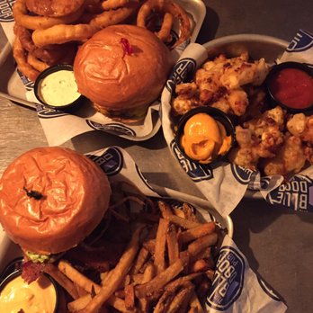 Blue Door Pub Como Ave - Mount Blucuvious w/ fries & Merica' sauce in front. Bacon blucy w/ onion rings & smack sauce in back. Cheese curds w/ garlic aioli in middle - Burgers Near Me - Minneapolis, Minnesota Blue Door Pub Como Ave - Mount Blucuvious w/ fries & Merica' sauce in front. Bacon blucy w/ onion rings & smack sauce in back. Cheese curds w/ garlic aioli in middle - Burgers Near Me - Minneapolis, Minnesota