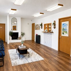 The Denture Studio - Comfortable reception area inside The Denture Studio where patients are welcomed for custom dentures, denture repairs, reline...