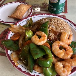 Spicy shrimp with rice and an egg roll. Spicy shrimp with rice and an egg roll.