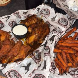 Large Wings - half Jamaican jerk and half Ragin Cajun with a side of sweet potato fries