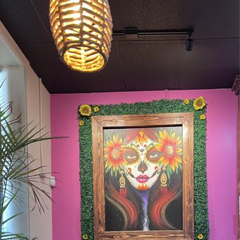 Frida's Brunch & Cantina - a painting of a woman with sunflowers - Breakfast & Brunch Near Me - Grants Pass, Oregon