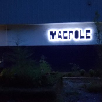 Maepole - the front of a building lit up at night - New American Near Me - Athens, Georgia