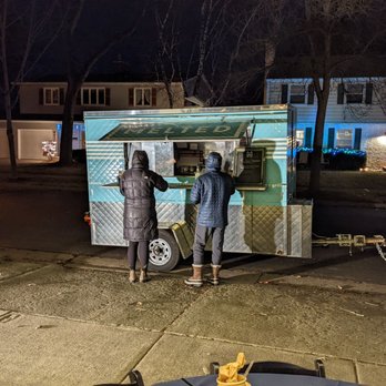 Melted - a couple of people standing in front of a food truck - Food Trucks Near Me - Madison, Wisconsin