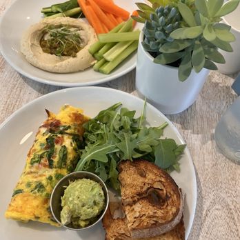 Pura Vida Miami - The omelette with avocado and sourdough toast. The hummus plate - Breakfast & Brunch Near Me - Sarasota, Florida Pura Vida Miami - The omelette with avocado and sourdough toast. The hummus plate - Breakfast & Brunch Near Me - Sarasota, Florida