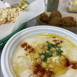 Hummus with falafel, pita and pickles.