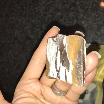 Mrs Mason's - a hand holding a piece of cake - Candy Stores Near Me - Royal Oak, Michigan