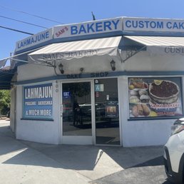 a car parked in front of the bakery a car parked in front of the bakery