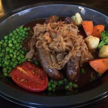 Leaky Cauldron™ - Bangers n Mash (sausage, mashed potatoes, onions, vegetables) - British Near Me - Orlando, Florida