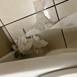 Used sanitary pad BEHIND the toilet Used sanitary pad BEHIND the toilet