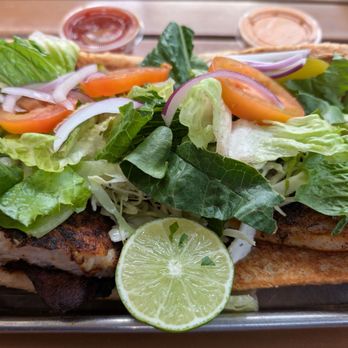Turf N Surf Po' Boy - Po' boy w/ blackened tilapia (top view) - Cajun/Creole Near Me - Austin, Texas Turf N Surf Po' Boy - Po' boy w/ blackened tilapia (top view) - Cajun/Creole Near Me - Austin, Texas
