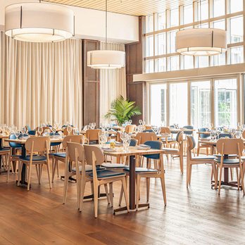 Indaco - a large dining room with wooden tables and chairs - Italian Near Me - Greenville, South Carolina Indaco - a large dining room with wooden tables and chairs - Italian Near Me - Greenville, South Carolina