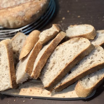Panacea Bread Home Bakery - a loaf of bread on a cutting board - Bakeries Near Me - New York, New York Panacea Bread Home Bakery - a loaf of bread on a cutting board - Bakeries Near Me - New York, New York