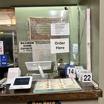 Lahori Restaurant - a counter with a menu and a phone - Pakistani Near Me - San Jose, California Lahori Restaurant - a counter with a menu and a phone - Pakistani Near Me - San Jose, California