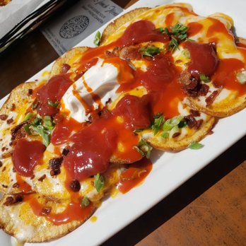 Hennessey's Tavern - Irish nachos with added chalula & ketchup - Irish Pub Near Me - Manhattan Beach, California Hennessey's Tavern - Irish nachos with added chalula & ketchup - Irish Pub Near Me - Manhattan Beach, California