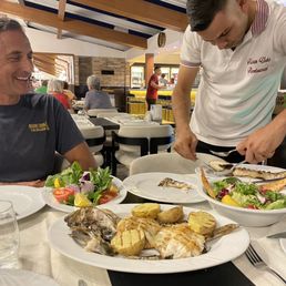 Waiter serving fish