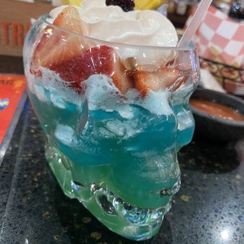 La Patrona Bar and Grill - a blue drink with strawberries and a pineapple - Mexican Near Me - Lumberton, North Carolina