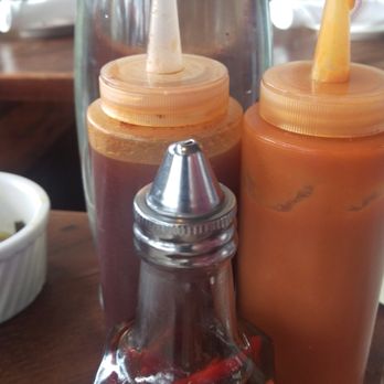 Revival - Carolina sauce on the left. Sweet potato habanero sauce on the right. Peppered vinegar in the middle - Southern Near Me - Minneapolis, Minnesota