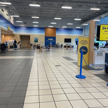 CarMax - A spacious CarMax showroom with seating areas, service counters, and a large digital display, featuring a high ceiling and bright lighting. - Used Car Dealers Near Me - Memphis, Tennessee