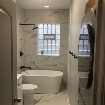 BBurnBuilders - Renovated Bathroom with updated hardware & washer/dresser unit. - General Contractors Near Me