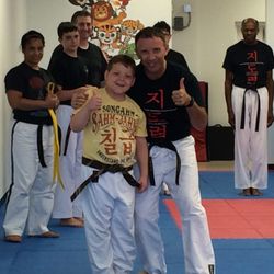 Elevate Martial Arts - Tommy getting his belt promotion!  A very patient Mr Santiago. !