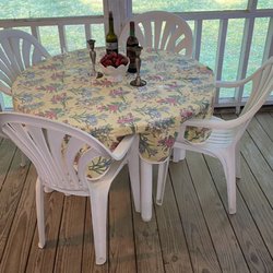 Small Town Estate Sales - Table and chairs staged with a beautiful tablecloth, wine chiller and glasses for an elegant look!