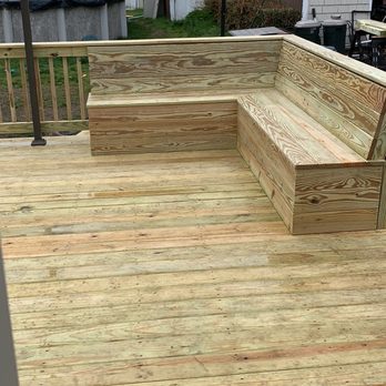 Sure Renovations - a wooden deck with benches and a fire hydrant - General Contractors Near Me