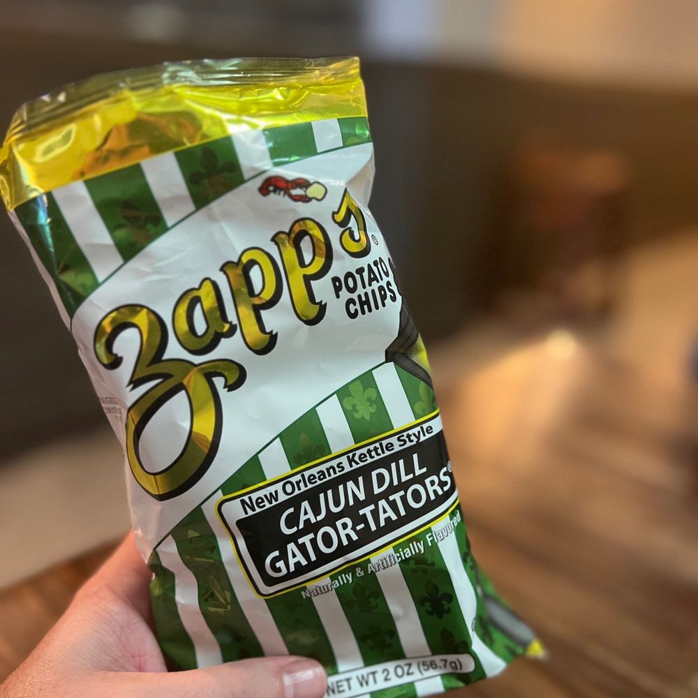 Benny Rinaldi’s - a hand holding a bag of chips - Pizza Near Me - North Charleston, South Carolina