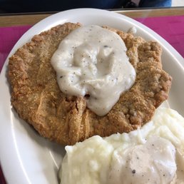 Giant serving of country fried steak with side of mashed potatoes