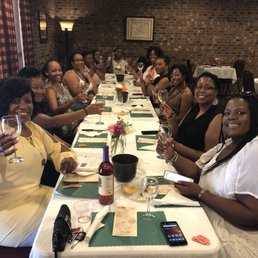 a group of women sitting at a long table