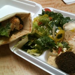 Falafel with hummus on pita bread with Greek salad