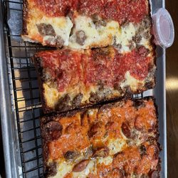 Pizza Pushers - On left: sausage pizza. On right: Winston Wolf