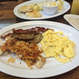 a plate of eggs, sausage, hash browns, and biscuits a plate of eggs, sausage, hash browns, and biscuits