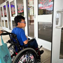 Cinema Cafe - Boy in wheelchair entering cinema
