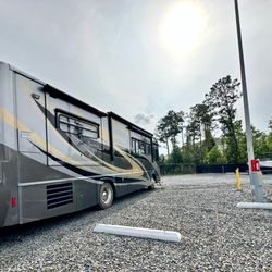 Powered Storage & Parking - RV parked in large space in Powered Storage & Parking facility in Leland
