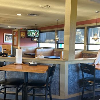 Pizza Hut - a woman sitting at a table - Pizza Near Me - Henderson, Texas