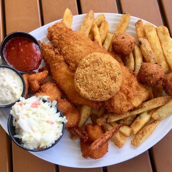 Doc's Seafood & Steaks - The seaman's platter which includes some shrimps, a fillet of fish and a cabb patty with fries and hush puppies. - Seafood Near Me - Corpus Christi, Texas Doc's Seafood & Steaks - The seaman's platter which includes some shrimps, a fillet of fish and a cabb patty with fries and hush puppies. - Seafood Near Me - Corpus Christi, Texas