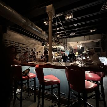 Doris Metropolitan - a bar with red leather chairs - New American Near Me - New Orleans, Louisiana