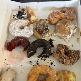 Uneaten variety of donuts.  unfortunately, they are not that good.  The toasted coconut is so dense and dry.