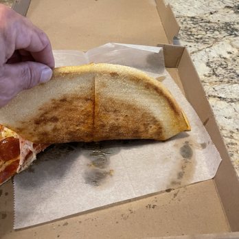 Dantes Italiano - Undercarriage of pepperoni pie - Italian Near Me - Raleigh, North Carolina