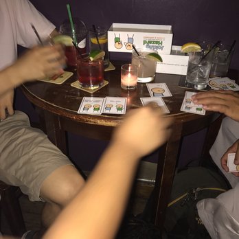 The Immigrant Tap Room - people sitting at a table with drinks - Bars Near Me - New York, New York