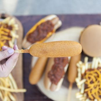 Wienerschnitzel - a person holding a hot dog with chili and cheese - Hot Dogs Near Me - Oceanside, California Wienerschnitzel - a person holding a hot dog with chili and cheese - Hot Dogs Near Me - Oceanside, California