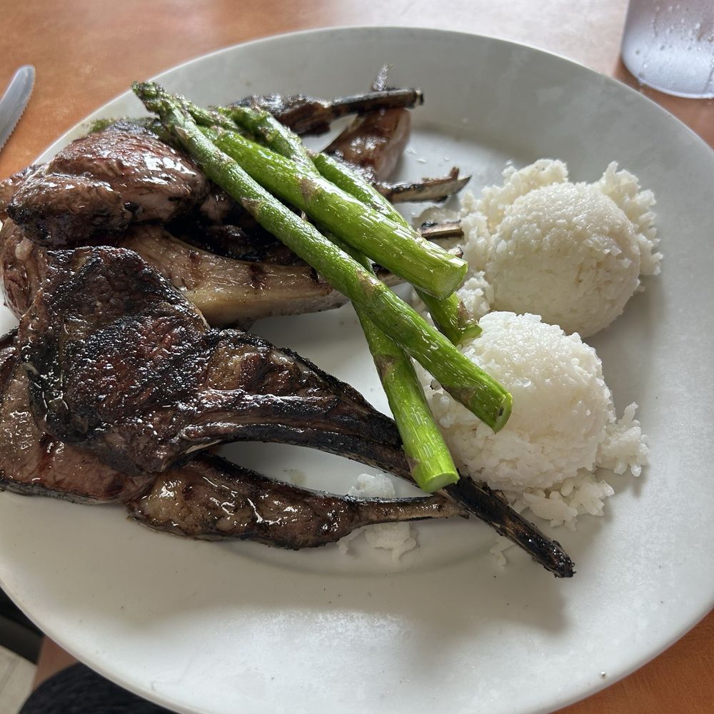 Ray's Café - 7 pieces of juicy/perfectly cooked rack of lamb with grilled fresh asparagus and two scoops of rice! Side salad was included. - American Near Me - Honolulu, Hawaii Ray's Café - 7 pieces of juicy/perfectly cooked rack of lamb with grilled fresh asparagus and two scoops of rice! Side salad was included. - American Near Me - Honolulu, Hawaii
