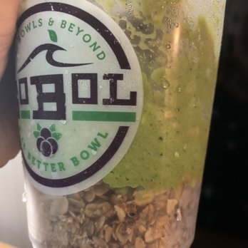 SoBoL - Half granola - A transparent cup containing a smoothie bowl with granola at the bottom and green fruit or toppings on top, labeled 'Better Bowls & Beyond.' - Juice Bars & Smoothies Near Me - Yonkers, New York