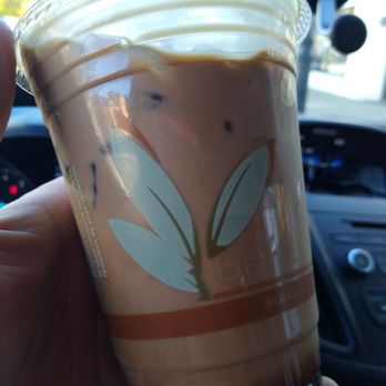 Nomad Coffee - a hand holding a cup of iced coffee - Coffee & Tea Near Me - Essex, Vermont Nomad Coffee - a hand holding a cup of iced coffee - Coffee & Tea Near Me - Essex, Vermont